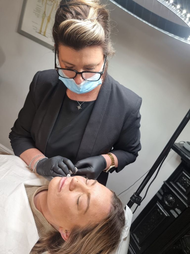 Practitioner performing lip treatment